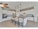 Bright kitchen boasts white cabinets, black countertops, and pendant lighting over island at 22927 E Via Del Oro --, Queen Creek, AZ 85142