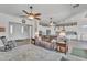Bright and open living area with stylish furnishings and ceiling fans, with an open layout to the kitchen at 22927 E Via Del Oro --, Queen Creek, AZ 85142