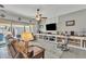 Cozy living room with comfortable seating, large windows, and a stylish entertainment center at 22927 E Via Del Oro --, Queen Creek, AZ 85142