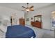 Bright bedroom with carpet, ceiling fan, and dark wood dressers at 22927 E Via Del Oro --, Queen Creek, AZ 85142