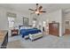 Bright bedroom with a ceiling fan, soft carpet, and a comfortable blue bed with a white bench at 22927 E Via Del Oro --, Queen Creek, AZ 85142