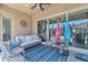 Cozy covered patio featuring comfortable seating, sliding glass doors, and stylish decor at 22927 E Via Del Oro --, Queen Creek, AZ 85142