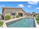 Inviting backyard pool with a travertine deck, perfect for relaxing and entertaining under the sunny sky at 22927 E Via Del Oro --, Queen Creek, AZ 85142