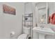 Cozy powder room with pedestal sink, decorative shelf, and colorful wall art at 22927 E Via Del Oro --, Queen Creek, AZ 85142