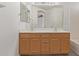 Bathroom featuring a double sink vanity with a large mirror at 22963 W La Pasada Blvd, Buckeye, AZ 85326