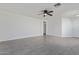 Bright and airy living room with a ceiling fan, and modern flooring at 22963 W La Pasada Blvd, Buckeye, AZ 85326