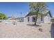 Backyard view showcasing a refreshing pool, covered patio, and desert-friendly landscaping for low maintenance at 2307 W Nido Ave, Mesa, AZ 85202