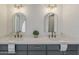 Close-up showcasing the double vanity with quartz countertop, gold fixtures, and arched mirrors at 2307 W Nido Ave, Mesa, AZ 85202