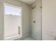 Tiled glass shower with modern fixtures and a clear door offering views to the outside at 2307 W Nido Ave, Mesa, AZ 85202