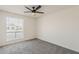 Bedroom featuring plush carpeting, ceiling fan, and a window offering natural light at 2307 W Nido Ave, Mesa, AZ 85202