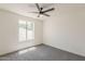 Bedroom features soft carpet, a ceiling fan, and a window providing natural light at 2307 W Nido Ave, Mesa, AZ 85202