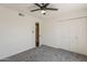 Bedroom includes carpet, ceiling fan, and access to the closet and bathroom at 2307 W Nido Ave, Mesa, AZ 85202