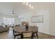 Bright dining area features a stylish wood table, seating, and view into the cozy living room at 2307 W Nido Ave, Mesa, AZ 85202