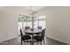 Cozy dining area with a round table, stylish chairs, and a view of the outdoor patio at 2307 W Nido Ave, Mesa, AZ 85202