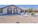 Single-story home featuring a low-maintenance desert landscape and arched window detailing at 2307 W Nido Ave, Mesa, AZ 85202