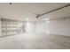 Large garage with shelving, utility connections, and ample storage or parking space at 2307 W Nido Ave, Mesa, AZ 85202