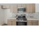 Modern kitchen features stainless steel appliances, white countertops and wood cabinets at 2307 W Nido Ave, Mesa, AZ 85202