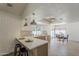 Bright, open kitchen with breakfast bar, stainless steel appliances, and view to dining area at 2307 W Nido Ave, Mesa, AZ 85202