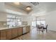 Modern kitchen with wood cabinets, stainless appliances, and an adjacent dining area overlooking the pool at 2307 W Nido Ave, Mesa, AZ 85202