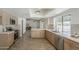 Spacious kitchen with wooden cabinets, stainless steel appliances, and an open layout flowing into the living area at 2307 W Nido Ave, Mesa, AZ 85202
