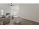Spacious living room boasts lots of light, vaulted ceiling, ceiling fan, and wood-style tile flooring at 2307 W Nido Ave, Mesa, AZ 85202