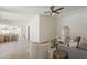 Spacious living room boasts lots of light, vaulted ceiling, and wood-style tile flooring, and entryways at 2307 W Nido Ave, Mesa, AZ 85202