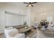 Inviting open-concept living room featuring a step-down design and a view of the dining area at 2307 W Nido Ave, Mesa, AZ 85202