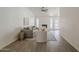 Spacious living room boasts lots of light, vaulted ceiling, ceiling fan, and wood-style tile flooring at 2307 W Nido Ave, Mesa, AZ 85202