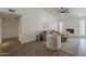 Open living room boasts lots of light, vaulted ceiling, ceiling fan, and wood-style tile flooring at 2307 W Nido Ave, Mesa, AZ 85202