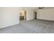 A bedroom with an ensuite bathroom, carpet, and natural light from the window at 2307 W Nido Ave, Mesa, AZ 85202
