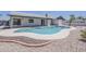 Inviting kidney-shaped pool with diving board and rock landscaping, perfect for outdoor relaxation and entertainment at 2307 W Nido Ave, Mesa, AZ 85202