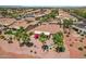 Aerial view of home with desert landscaping, firepit area, and covered patio with red umbrella at 23225 N Hank Raymond Dr, Sun City West, AZ 85375