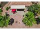 Aerial view of a patio with lounge chairs, desert landscaping, and a covered patio with dining at 23225 N Hank Raymond Dr, Sun City West, AZ 85375