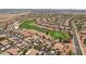 Scenic aerial view of a golf course community with lush green fairways, pools, and beautiful homes with red tile roofs at 23225 N Hank Raymond Dr, Sun City West, AZ 85375