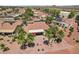 Aerial view of homes with desert landscaping featuring covered patio with red umbrella and firepit area at 23225 N Hank Raymond Dr, Sun City West, AZ 85375