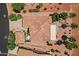 Aerial view of a home featuring tile roof, desert landscaping, an outdoor fire pit and covered patio at 23225 N Hank Raymond Dr, Sun City West, AZ 85375