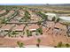 Aerial view of neighborhood with desert landscaping featuring covered patio and firepit area at 23225 N Hank Raymond Dr, Sun City West, AZ 85375