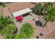 Aerial view of backyard featuring a patio with a red umbrella and a cozy firepit area at 23225 N Hank Raymond Dr, Sun City West, AZ 85375