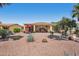 Expansive backyard featuring a covered patio, desert landscaping, and inviting seating areas for relaxation at 23225 N Hank Raymond Dr, Sun City West, AZ 85375
