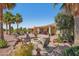 Beautiful backyard with a cozy fire pit area, surrounded by lush landscaping, ideal for outdoor gatherings at 23225 N Hank Raymond Dr, Sun City West, AZ 85375