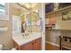 Bathroom sink and mirror leading to a closet with ample storage at 23225 N Hank Raymond Dr, Sun City West, AZ 85375