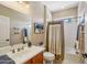Well-lit bathroom features a neutral color scheme, shower/tub combo, and single sink vanity, exuding a relaxing ambiance at 23225 N Hank Raymond Dr, Sun City West, AZ 85375