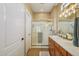 Bright bathroom features double sinks, vanity, and a glass-enclosed shower for a functional space at 23225 N Hank Raymond Dr, Sun City West, AZ 85375