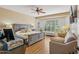 Inviting main bedroom with a ceiling fan, large windows, and neutral decor creates a serene retreat at 23225 N Hank Raymond Dr, Sun City West, AZ 85375