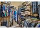 Walk-in closet featuring plentiful hanging and shelf storage space for clothes, shoes, and accessories at 23225 N Hank Raymond Dr, Sun City West, AZ 85375