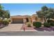 Charming single-story home with well-manicured landscaping and a two-car garage at 23225 N Hank Raymond Dr, Sun City West, AZ 85375