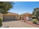 Single-story home with desert landscaping, tile roof and attached two car garage at 23225 N Hank Raymond Dr, Sun City West, AZ 85375