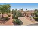 Beautiful home featuring a tile roof, lush landscaping, and a private gated entrance at 23225 N Hank Raymond Dr, Sun City West, AZ 85375