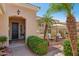 Inviting front entrance with a desert landscape, a seating area, and mature palm trees at 23225 N Hank Raymond Dr, Sun City West, AZ 85375