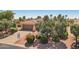 Single-story home featuring a two-car garage, desert landscaping with rock cover, trees, and shrubs at 23225 N Hank Raymond Dr, Sun City West, AZ 85375